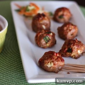 Close-up of golden-brown Asian Turkey Meatballs with Chili Garlic Glaze, garnished with green onions.