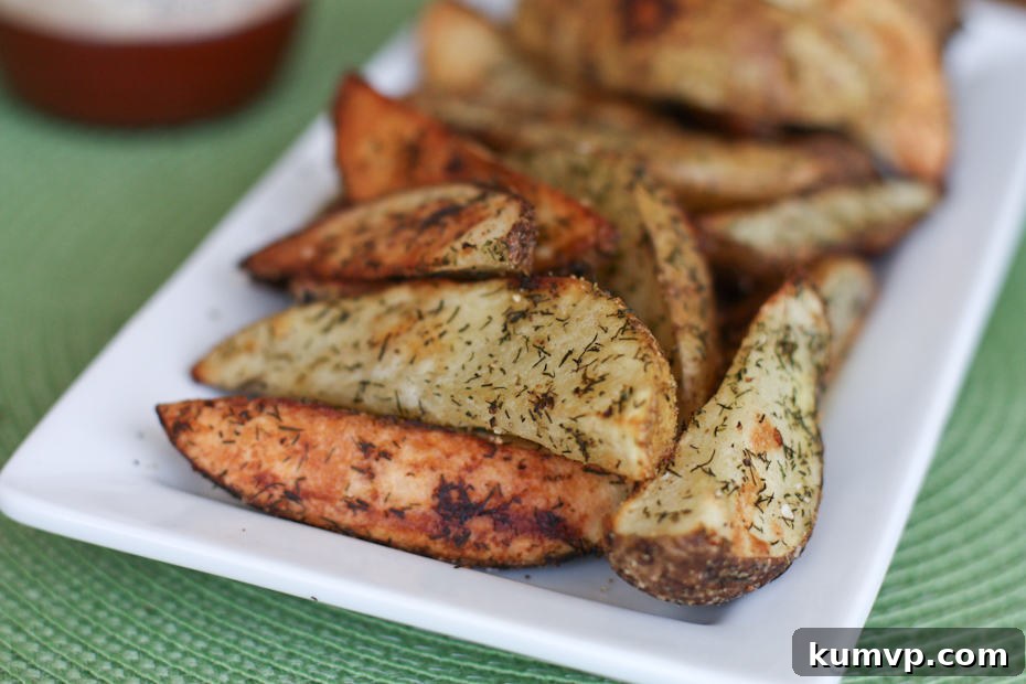 Oven Roasted Potato Wedges with Dill make a great side dish to your burgers all summer long. Easy to make and ready in 30 minutes! roasted potato wedges with dill on white plate