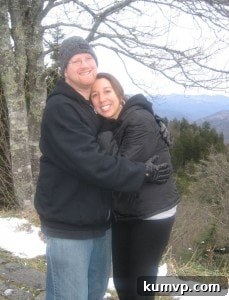 Two children, likely siblings, playing joyfully in the fresh, powdery snow during their memorable Smoky Mountains Thanksgiving trip, bundled in winter gear.
