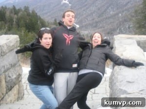 A heartwarming family moment captured in the stunning Smoky Mountains, perhaps posing on a charming bridge or a scenic spot amidst the vibrant autumn foliage.