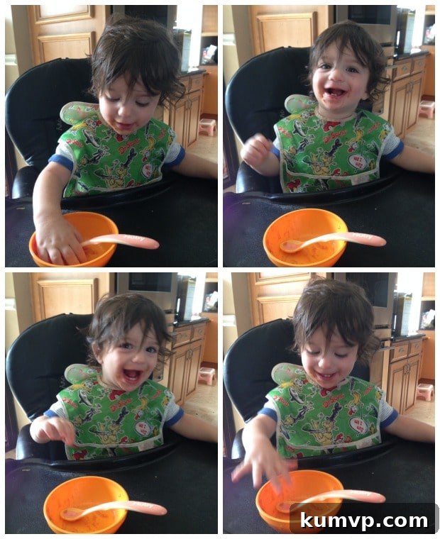 A young child happily eating a bowl of spaghetti squash with turkey bolognese, illustrating its kid-friendly appeal.