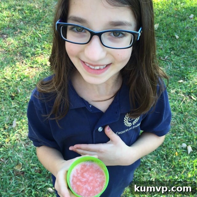 Dynamic Berry Citrus Ginger Blend 2 A close-up shot of the Strawberry, Grapefruit, and Ginger Smoothie in a glass, showcasing its appealing creamy texture and inviting pink-orange hue, ready for a healthy sip.