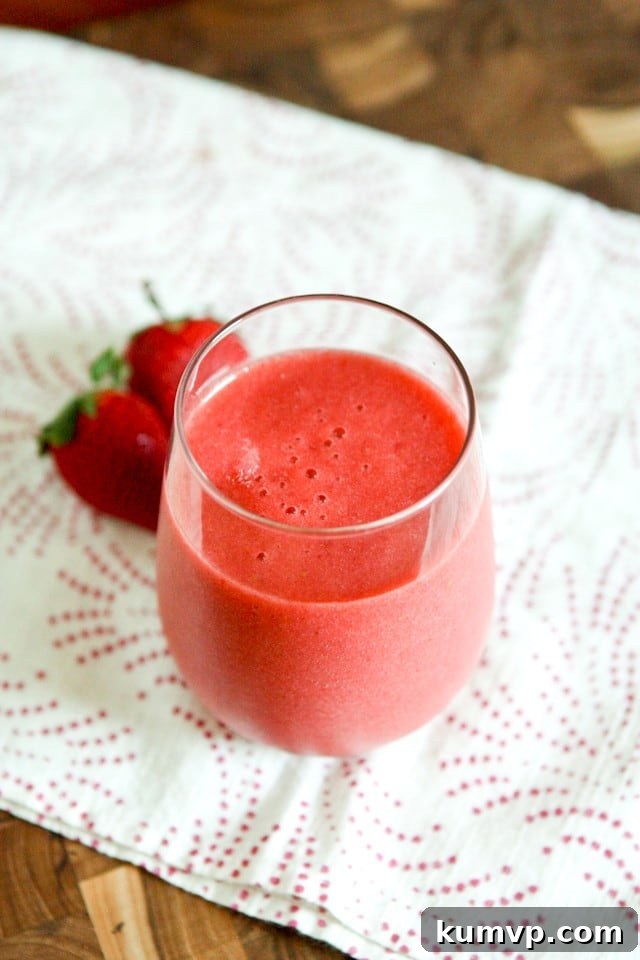Refreshing Smoothie for Wellness A beautifully presented glass of Strawberry, Grapefruit, and Ginger Smoothie, highlighting its vibrant color and smooth texture, ready to be enjoyed for its detoxifying and refreshing qualities.