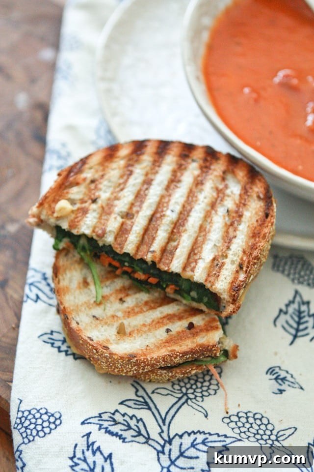 Mediterranean Veggie Hummus Panini 3 Close-up of a freshly made Hummus and Veggie Panini, sliced in half