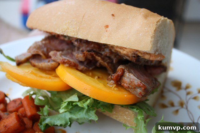 Harissa Steak Sandwich: A Gourmet Delight Harissa Steak Sandwich with perfectly cooked steak, fresh yellow tomatoes, and harissa mayo on Cuban bread