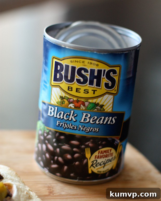 Delicious Black Bean, Mango, and Avocado Salsa ready to serve. Overhead view of a prepared bowl of Mango Avocado and Black Bean Salsa, highlighting the texture and color combination. A perfect healthy dip or topping. Recipe via aggieskitchen.com