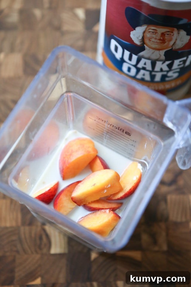 Peach Pie Smoothie with a Free Simply Summer eCookbook 4 Close-up of a refreshing Peach Pie Smoothie in a glass, garnished with fresh peach slices