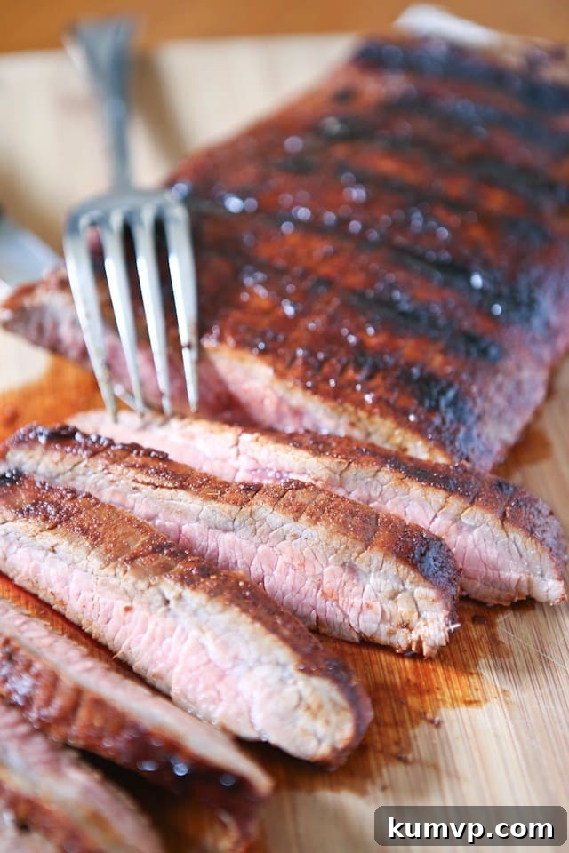 Grilled Flank Steak seasoned with a flavorful blend of brown sugar, chili powder, smoked paprika & cinnamon - fire up your grill for this one this weekend! Grilled Flank Steak with a Sweet & Spicy Spice Rub, ready for serving